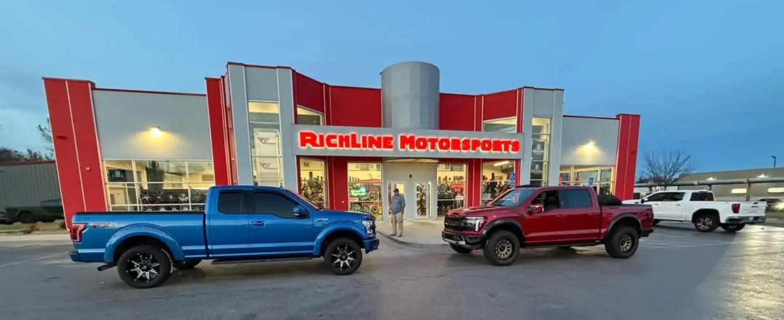 Exterior view of Richline Motorsports shop in O’Fallon, Illinois, showcasing trucks and signage.