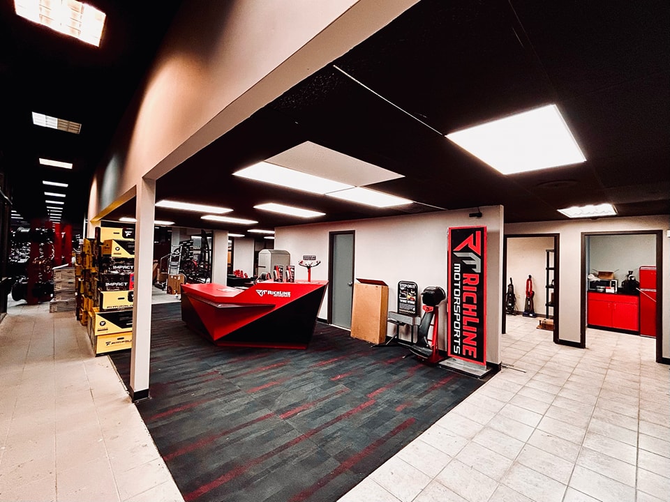 View of the Richline Motorsports red and black office area with automotive product display shelves.